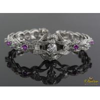 Pulsera realizada en oro blanco con diamantes, brillantes y rubíes.