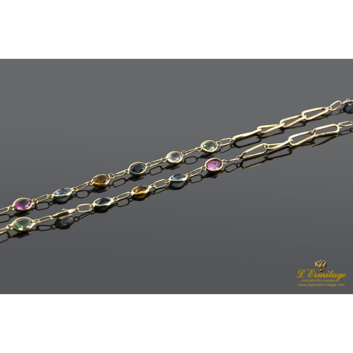 Collar oro amarillo con piedras de color.