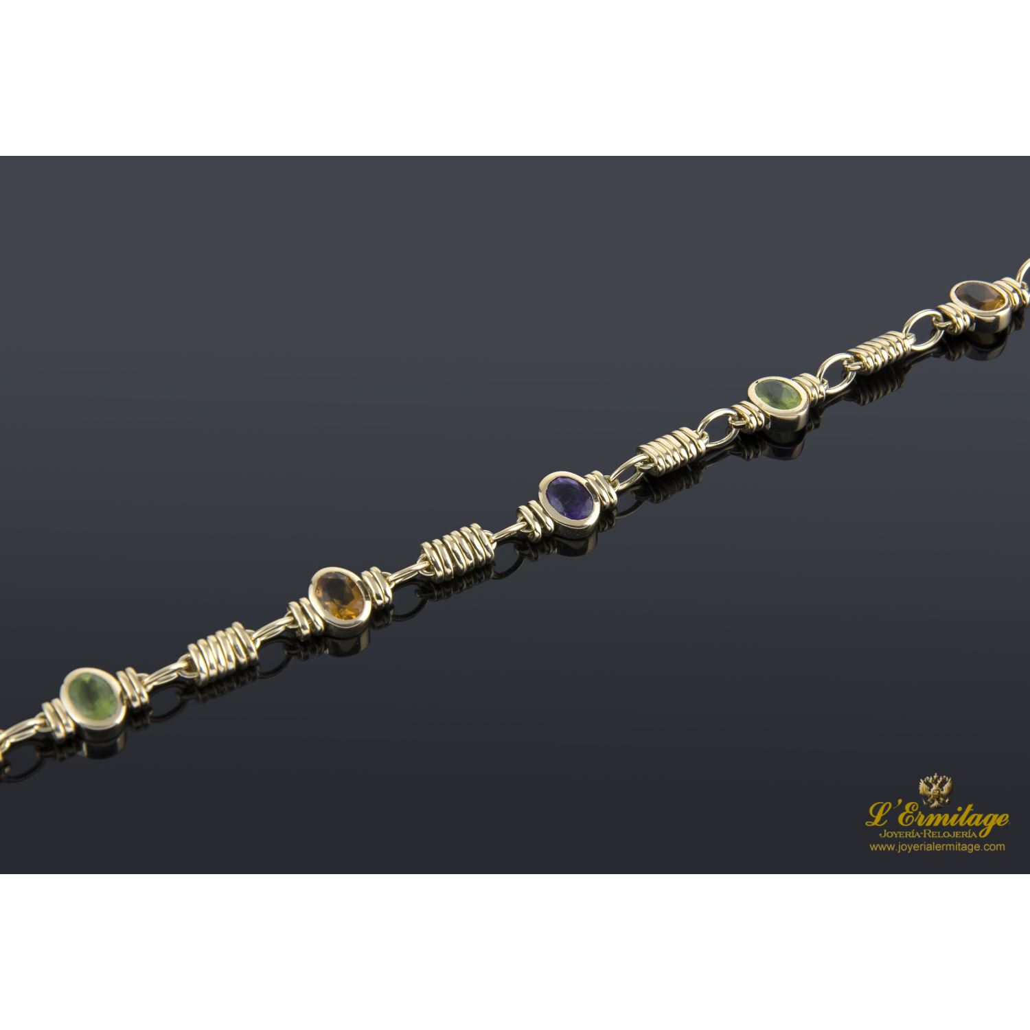 Pulsera oro amarillo y piedras de color.