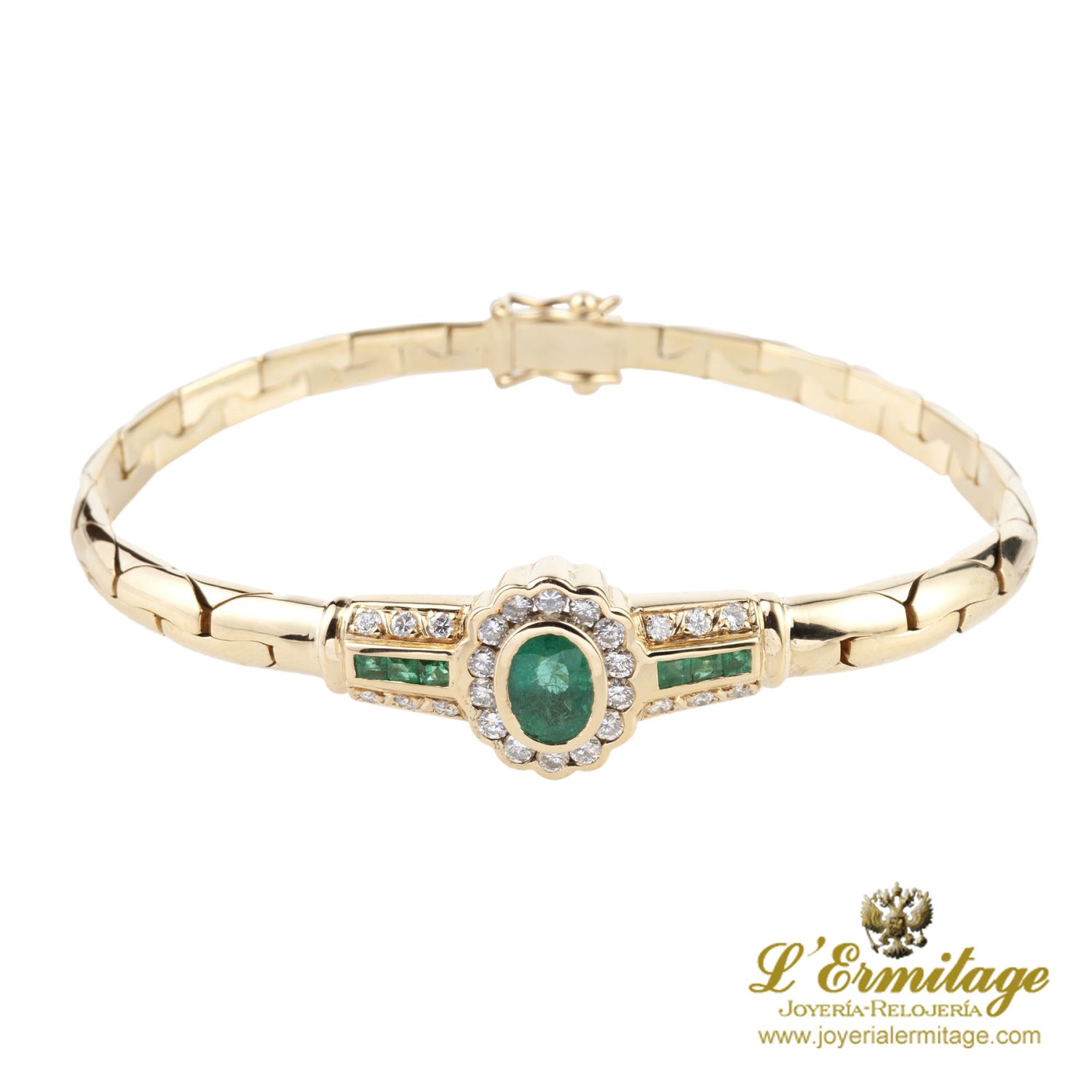 Pulsera en oro amarillo con esmerladas y brillantes.