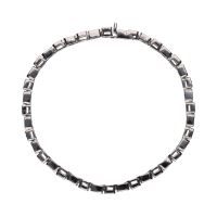 Pulsera tipo riviere en oro blanco con brillantes en chatón.