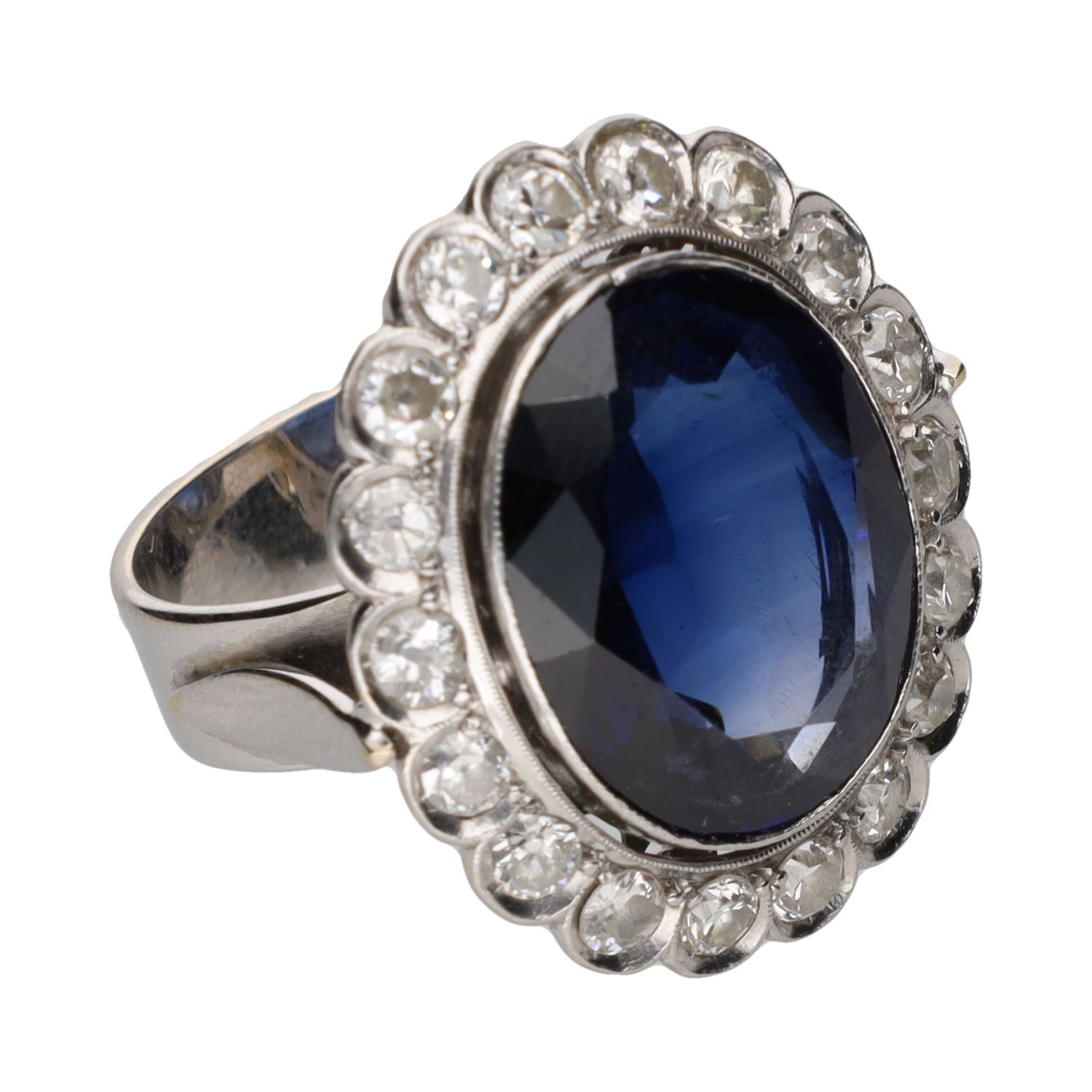 Sortija antigua en oro blanco con cristal azul central y orla de diamantes. Talla 10.