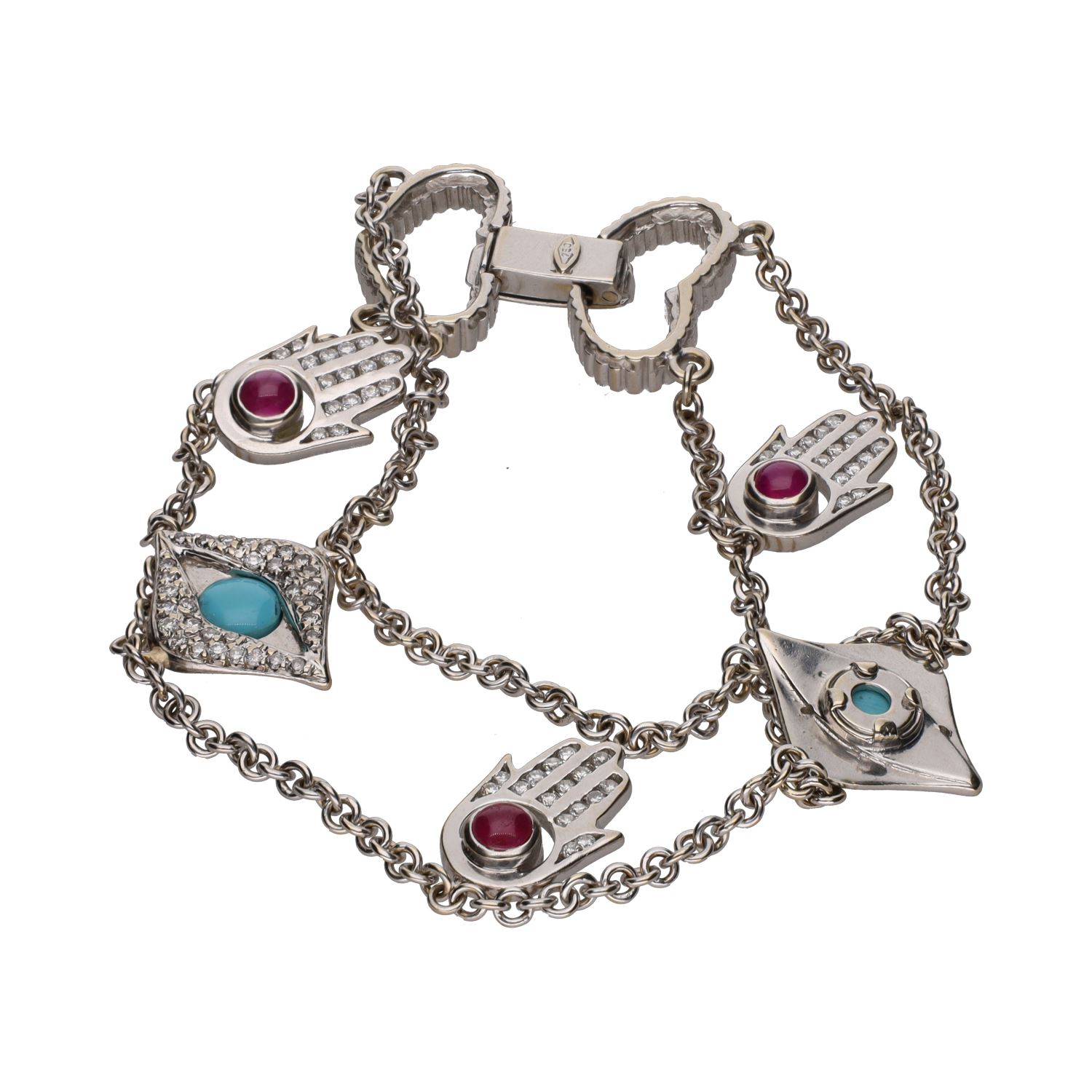 Pulsera en oro blanco con motivos arábigos turquesas y rubíes.