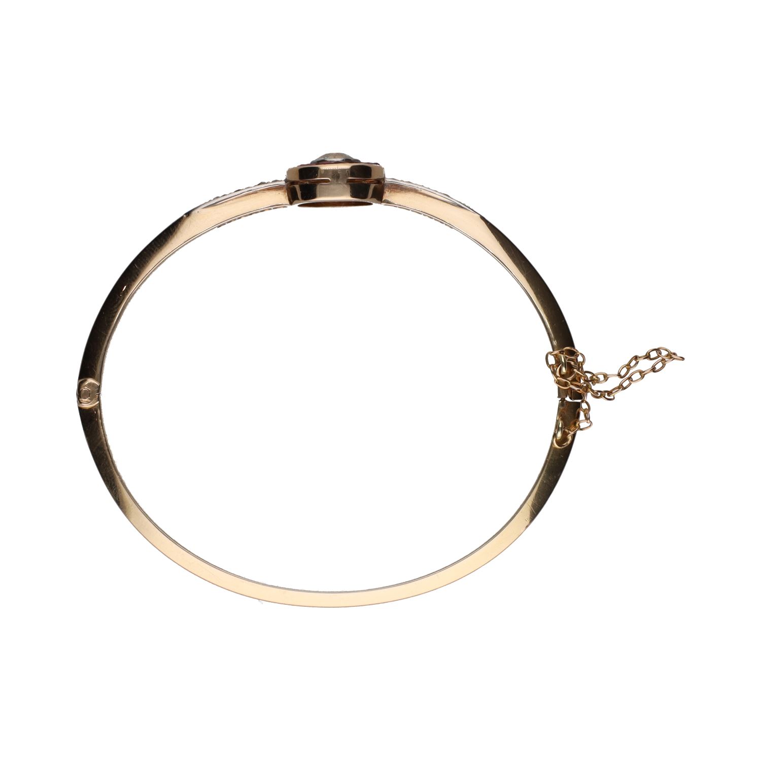 Pulsera rígida antigua en oro amarillo con diamantes y rubíes.