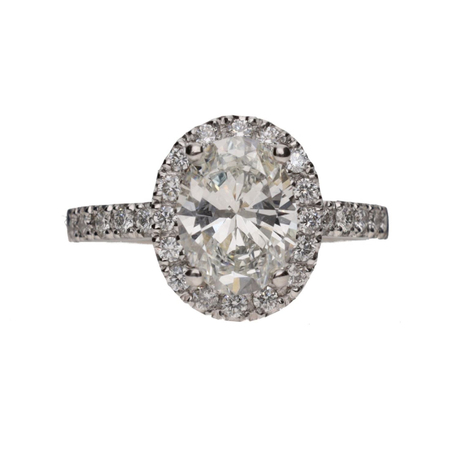 Sortija en platino con diamante oval y orla de brillantes. Talla 11.