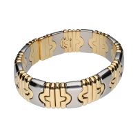 Pulsera abierta parentesis de bulgari en acero y oro.