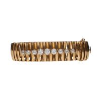 Pulsera rígida ancha en oro amarillo con brillantes.