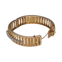 Pulsera rígida ancha en oro amarillo con brillantes.